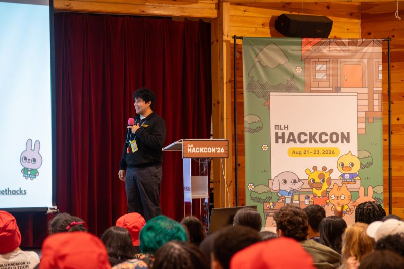 Adrian speaking on stage at Major League Hacking’s HackCon 2026.