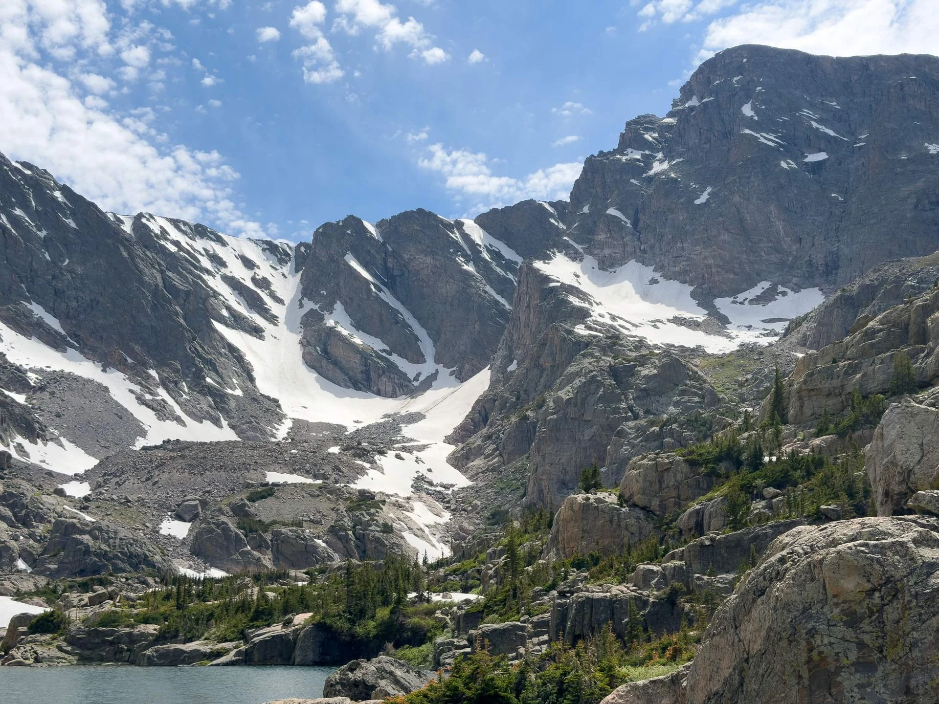 Snow-lined mountain peaks above an alpine lake, photographed during Adrian’s summer in Colorado.